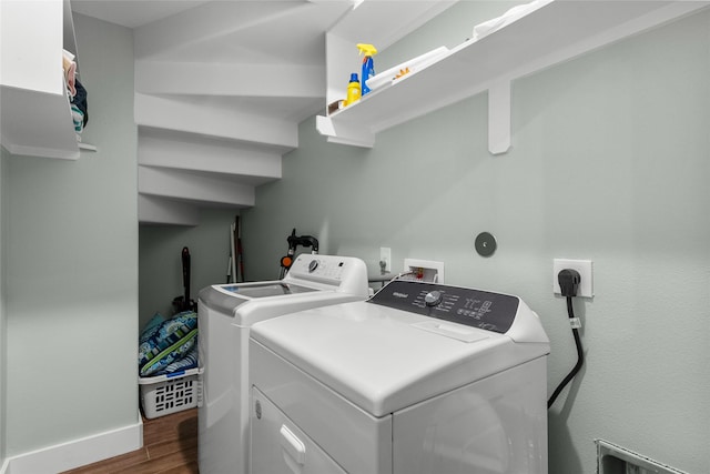 22318 Vista Del Mar, Galveston, TX 77554 - washroom featuring washing machine and clothes dryer, wood finished floors, laundry area, and baseboards