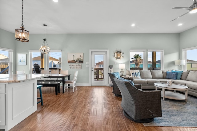 22318 Vista Del Mar, Galveston, TX 77554 - living room with baseboards, recessed lighting, wood finished floors, and ceiling fan with notable chandelier