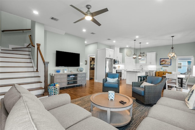 22318 Vista Del Mar, Galveston, TX 77554 - living area with recessed lighting, stairway, visible vents, ceiling fan with notable chandelier, and wood finished floors