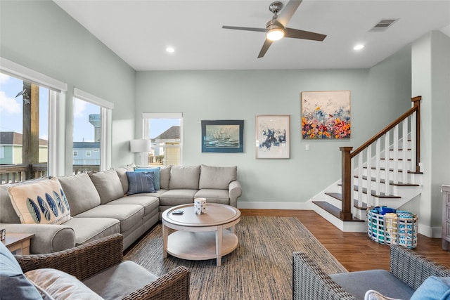 living room featuring recessed lighting, visible vents, stairway, wood finished floors, and baseboards