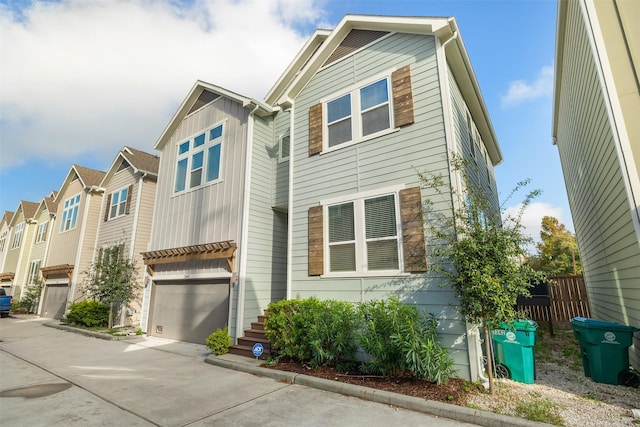 view of front of home featuring a residential view, concrete driveway, and an attached garage