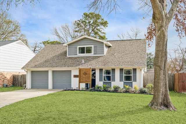 view of front of house with an attached garage, driveway, fence, and a front lawn