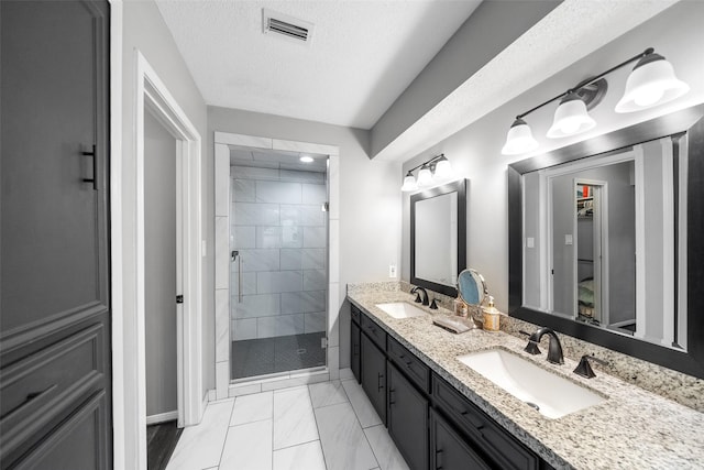 full bath featuring double vanity, a sink, visible vents, and a shower stall