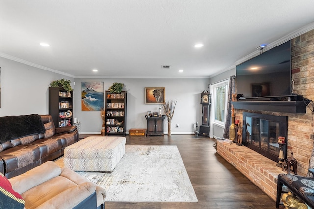 living room featuring recessed lighting, dark wood-style flooring, baseboards, a brick fireplace, and crown molding