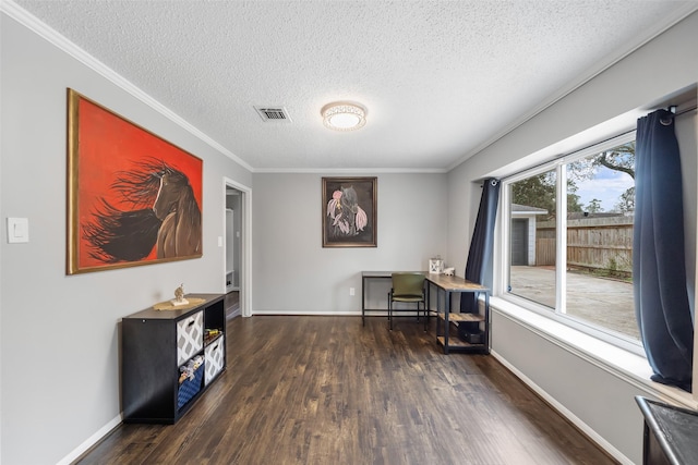 home office featuring a textured ceiling, dark wood-type flooring, visible vents, baseboards, and ornamental molding