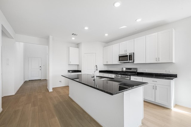 kitchen with light wood-type flooring, visible vents, appliances with stainless steel finishes, and a sink