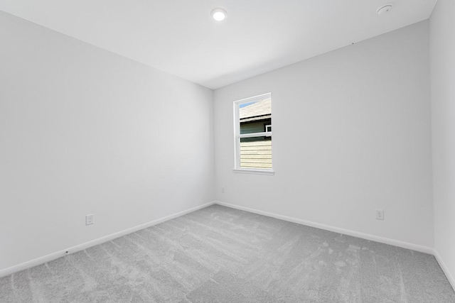 unfurnished room with baseboards and carpet floors