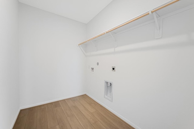 laundry area with hookup for a washing machine, baseboards, hookup for an electric dryer, laundry area, and light wood-style floors