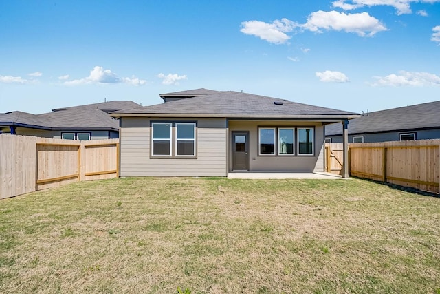 rear view of house featuring a patio area, a lawn, and a fenced backyard