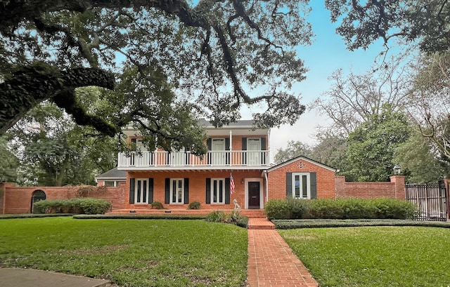 view of front of home with brick siding, crawl space, fence, and a balcony