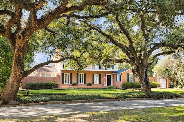 single story home featuring a front yard, crawl space, and brick siding