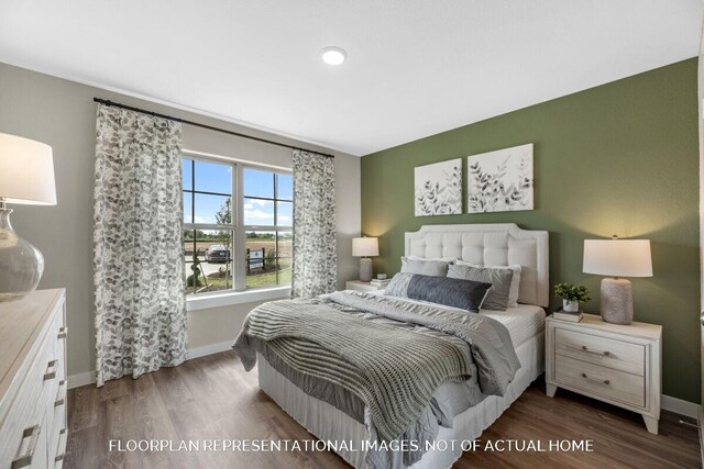 bedroom featuring wood finished floors and baseboards