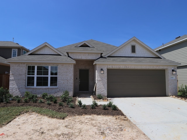 22431 Birchfield Grove Ln, New Caney, TX 77357 - view of front of home featuring an attached garage, brick siding, roof with shingles, and concrete driveway