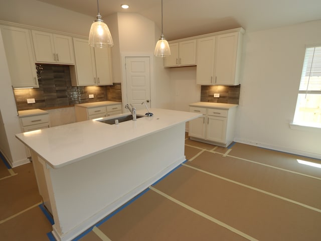 22431 Birchfield Grove Ln, New Caney, TX 77357 - kitchen featuring white cabinetry, tasteful backsplash, a center island with sink, a sink, and recessed lighting