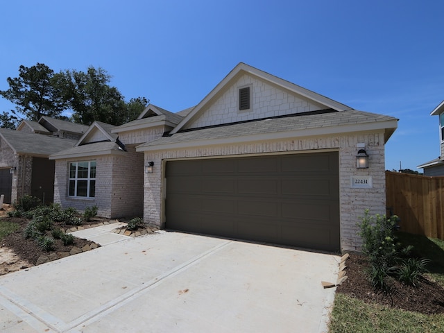 22431 Birchfield Grove Ln, New Caney, TX 77357 - view of front of home featuring an attached garage, concrete driveway, roof with shingles, and stone siding