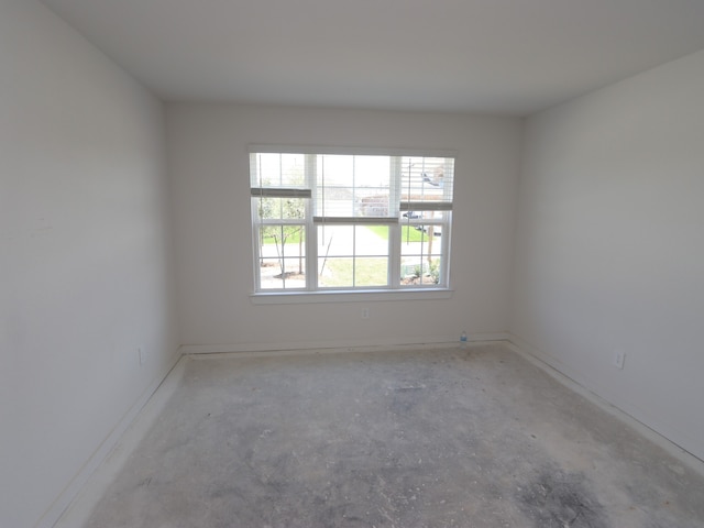 22431 Birchfield Grove Ln, New Caney, TX 77357 - empty room featuring baseboards and unfinished concrete floors