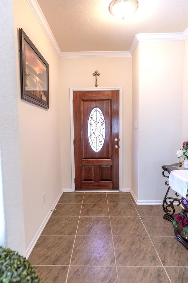 foyer entrance with baseboards, dark tile patterned flooring, and crown molding