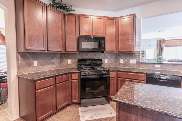 kitchen with black appliances, dark stone counters, decorative backsplash, and brown cabinetry