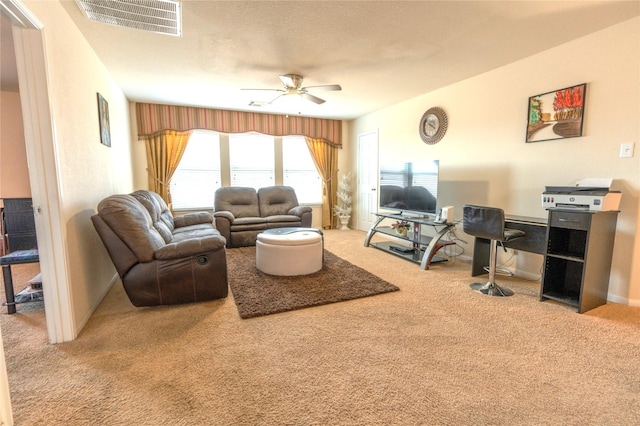 living area with ceiling fan, carpet floors, a textured ceiling, and visible vents