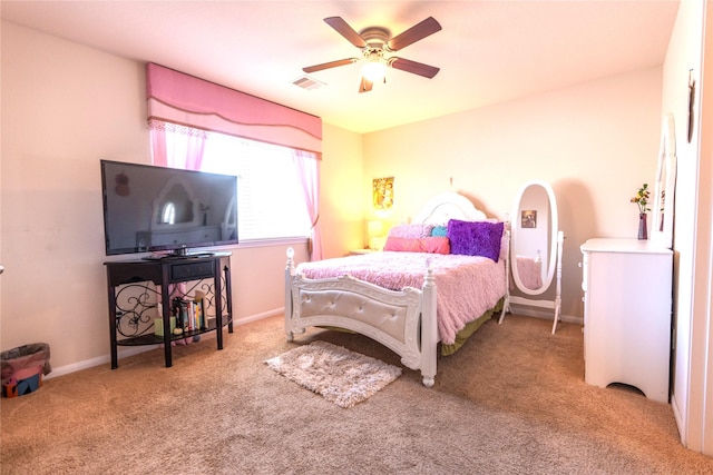 bedroom featuring baseboards, a ceiling fan, visible vents, and light colored carpet