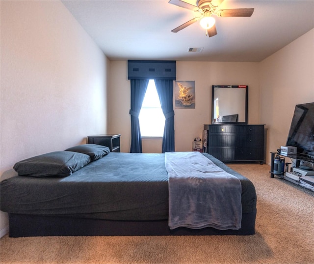 carpeted bedroom with visible vents and a ceiling fan