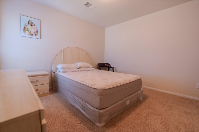 bedroom featuring light colored carpet, visible vents, and baseboards