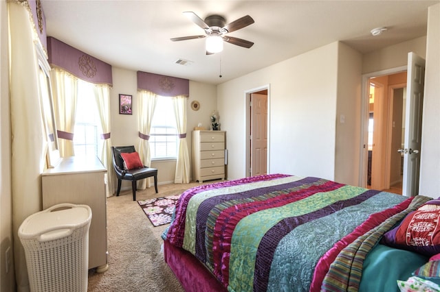 bedroom featuring light colored carpet, ceiling fan, and visible vents