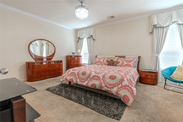 bedroom featuring ornamental molding, light carpet, a notable chandelier, and visible vents