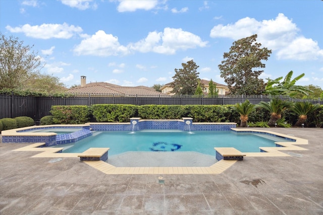 view of swimming pool with a patio, a fenced backyard, and a pool with connected hot tub