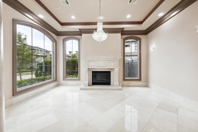 unfurnished living room with a wealth of natural light and a raised ceiling