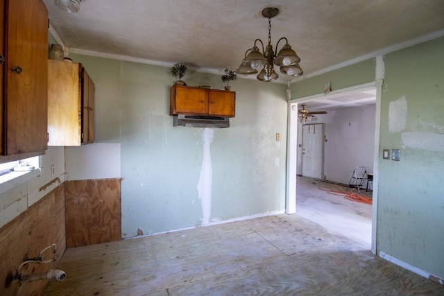 2420 Harriot St, Beaumont, TX 77705 - kitchen featuring brown cabinetry, decorative light fixtures, and crown molding