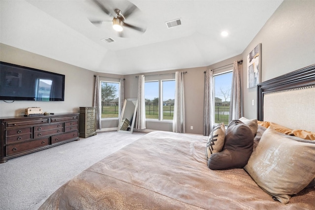 bedroom with a raised ceiling, visible vents, light carpet, ceiling fan, and access to outside