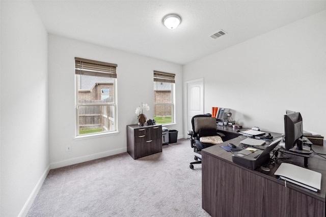 office with baseboards, visible vents, and light colored carpet