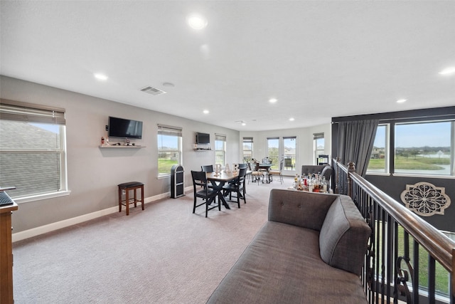 interior space featuring recessed lighting, visible vents, light carpet, and baseboards