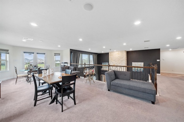 dining room with light carpet, baseboards, and recessed lighting