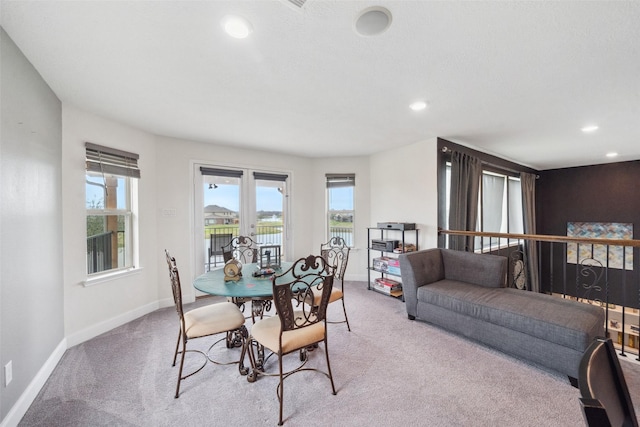 dining room with light carpet, baseboards, and recessed lighting