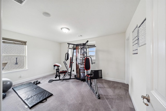 exercise area with carpet, visible vents, and baseboards