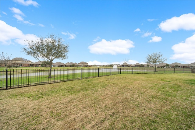 view of yard with a residential view and fence