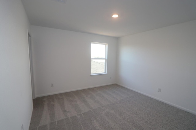 carpeted spare room with recessed lighting and baseboards