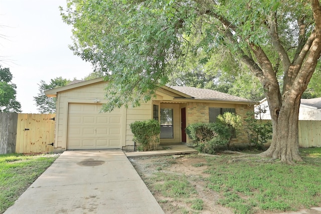 single story home featuring an attached garage, driveway, and brick siding