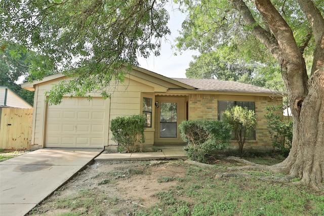 ranch-style house featuring a garage, concrete driveway, and brick siding