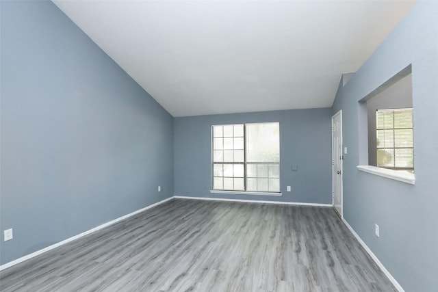 unfurnished room featuring light wood-style floors, baseboards, and a wealth of natural light