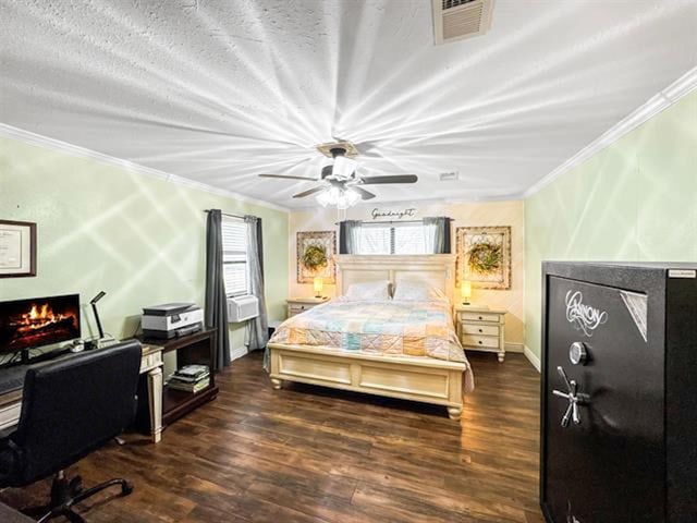 bedroom with a warm lit fireplace, visible vents, dark wood-type flooring, and crown molding