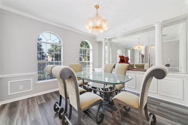 dining space with ornamental molding, dark wood-style flooring, an inviting chandelier, ornate columns, and a decorative wall