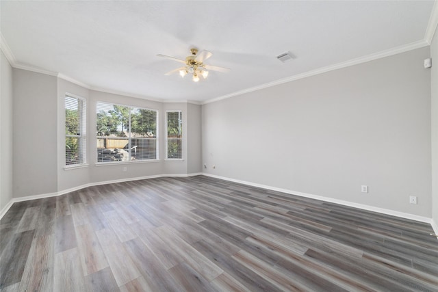 spare room with ornamental molding, dark wood-style flooring, visible vents, and baseboards