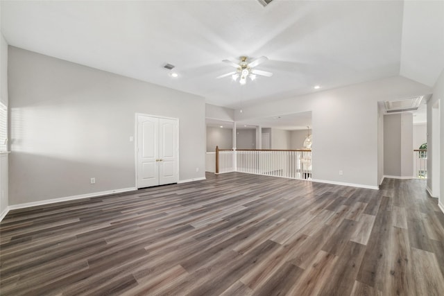 empty room featuring dark wood-style floors, baseboards, visible vents, and attic access