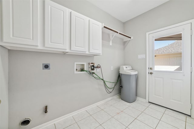 clothes washing area featuring cabinet space, baseboards, washer hookup, electric dryer hookup, and light tile patterned flooring