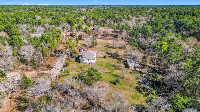 birds eye view of property with a forest view