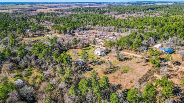 birds eye view of property with a view of trees