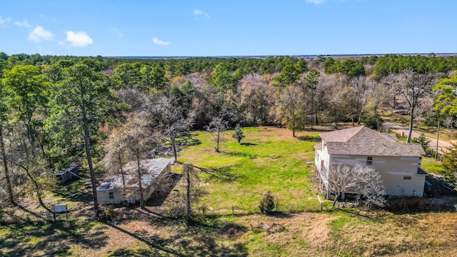 drone / aerial view featuring a forest view